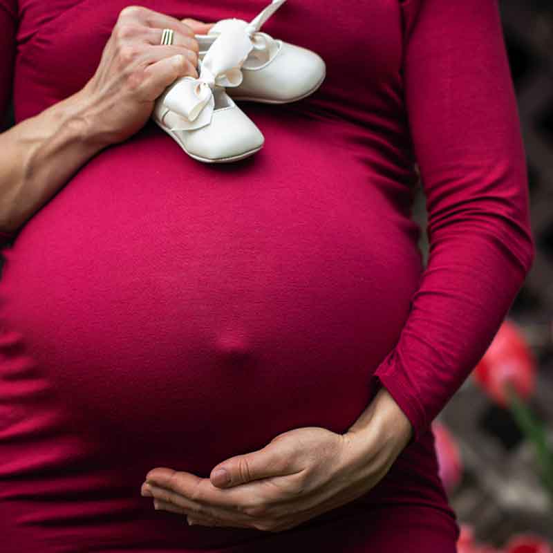 Osteopathic treatment of a pregnant woman in action image of